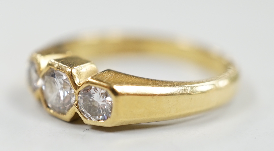 A modern 18ct gold and collet set three stone diamond ring, size M/N, gross weight 5 grams.